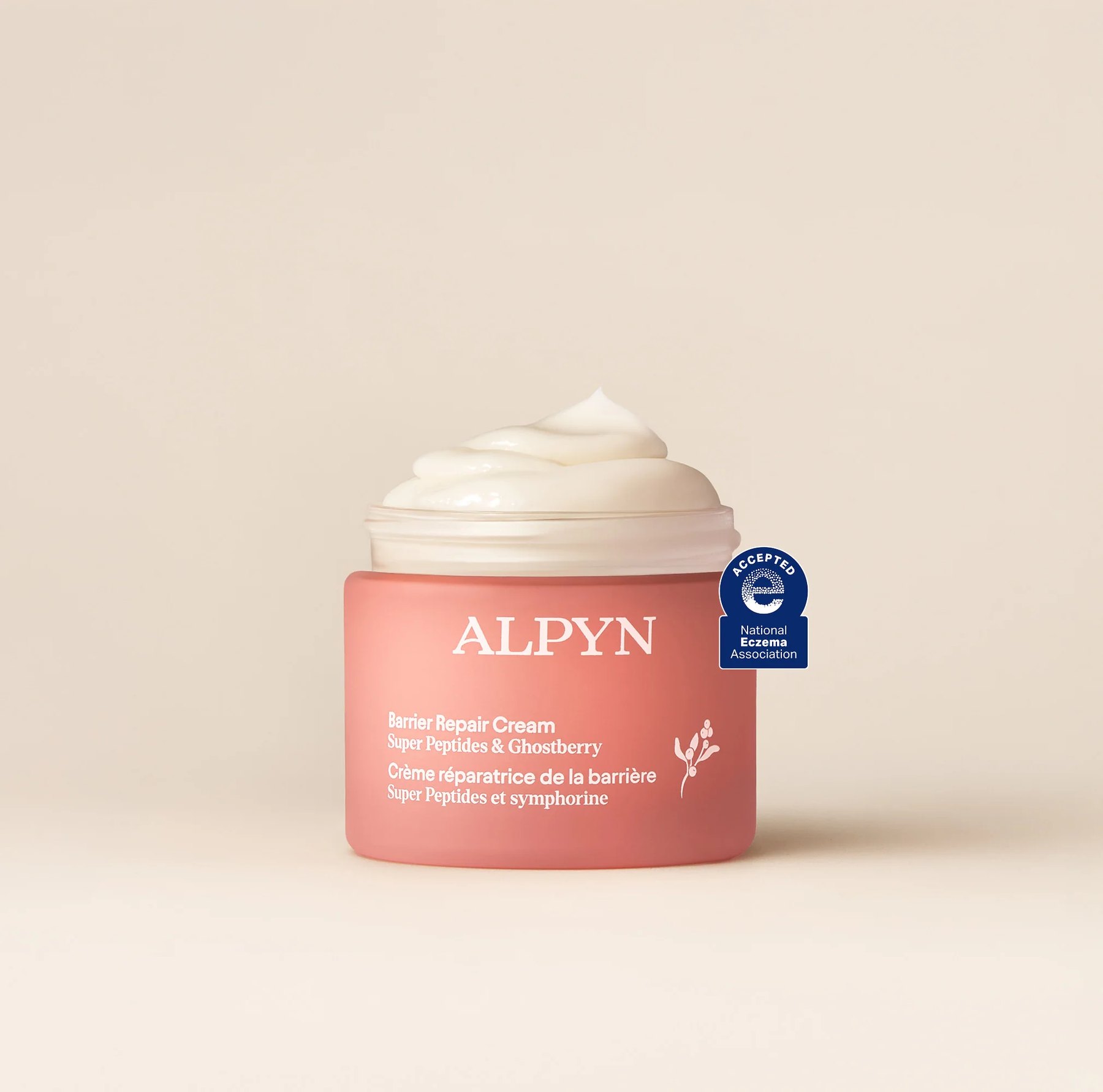Open jar of Alpyn Barrier Repair Cream with whipped white cream.