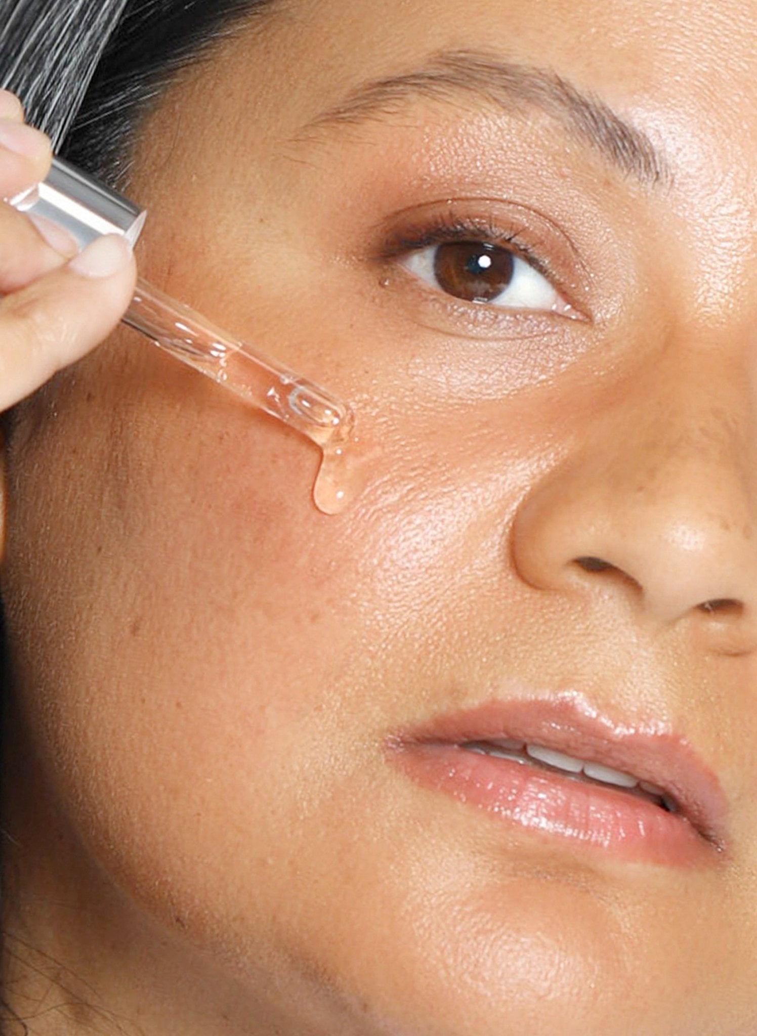 Theorem Serum Boost smoothed onto the face.