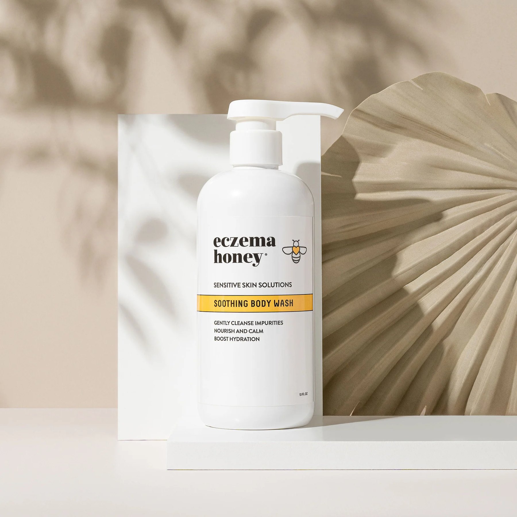 Eczema Honey Soothing Body Wash bottle on neutral backdrop.