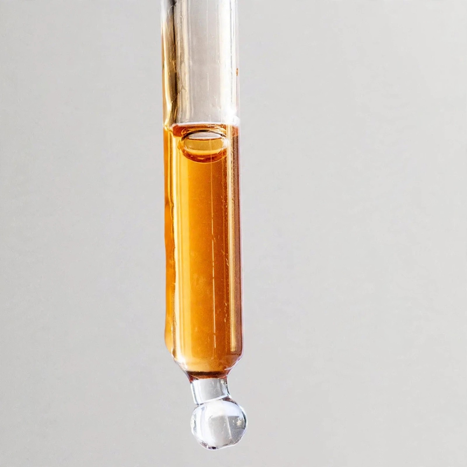 A slow drop of amber oil